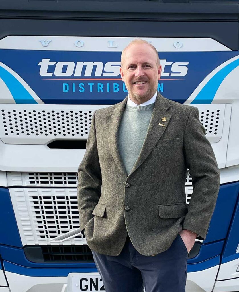 Andrew Tucknott, in front of Tomsett's Volvo truck