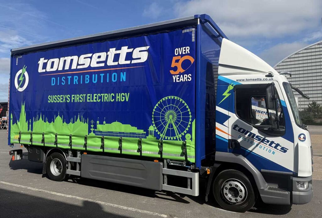 Tomsetts Electric HGV with side curtains showing Brighton Skyline