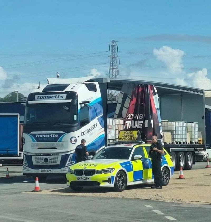 Sussex Police car with Tomsetts truck on a police exercise